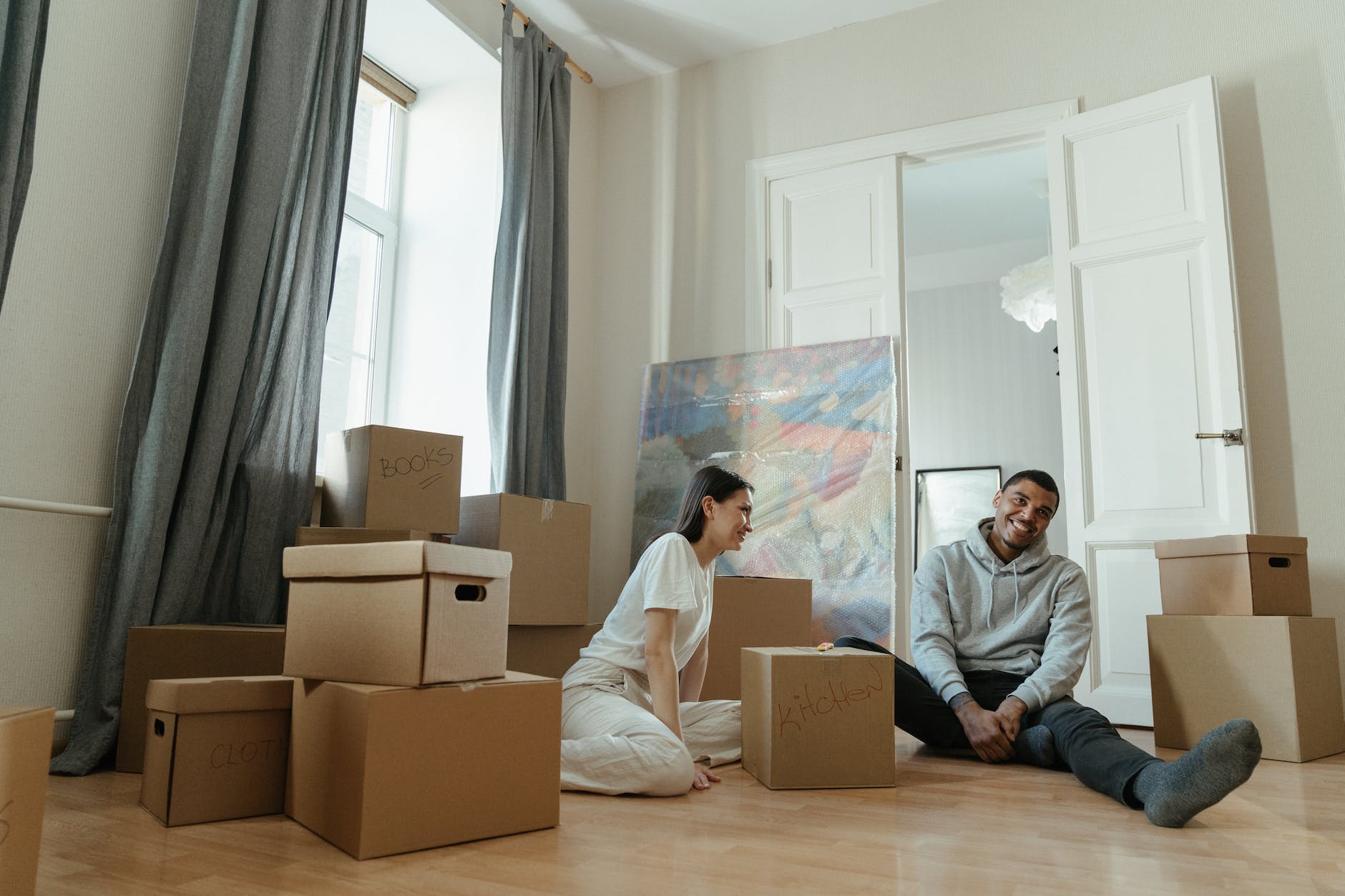 man in gray long sleeve shirt sitting beside woman in white long sleeve shirt